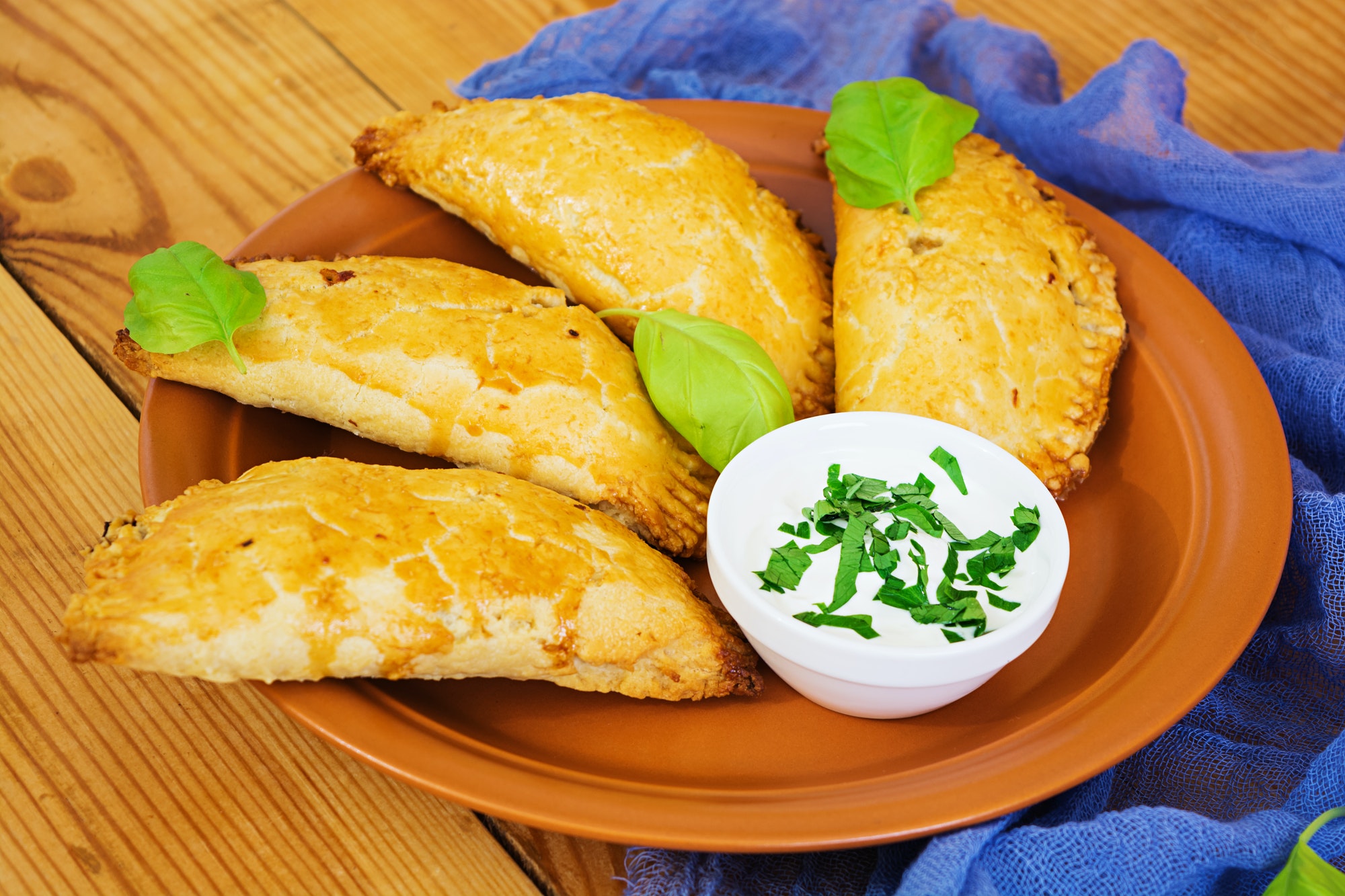 Baked empanadas on wooden background